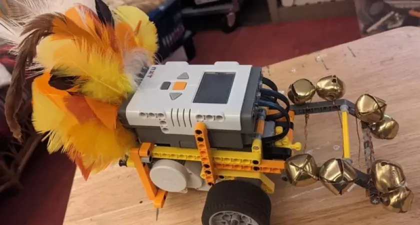 A robot that a student created featuring orange feathers on the back