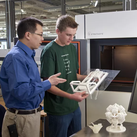 Research technician using 3d printer 