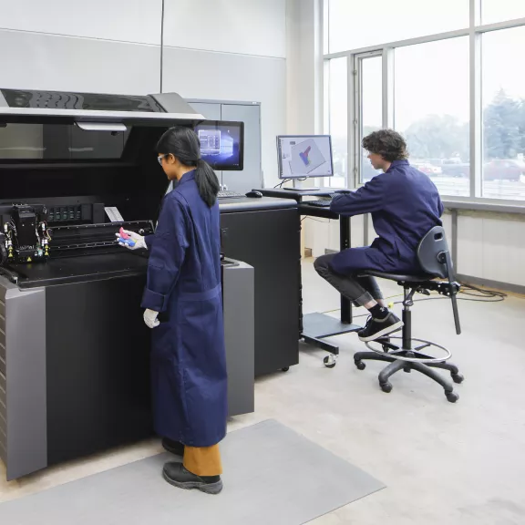 Research technician using 3d printer