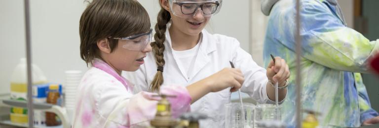 Two children doing experiment in science lab