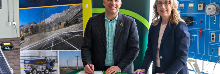 Stuart Callum & Janine Sullivan signing a MOU while smiling at camera