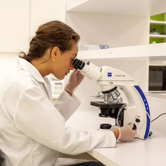 RDP student looking through microscope