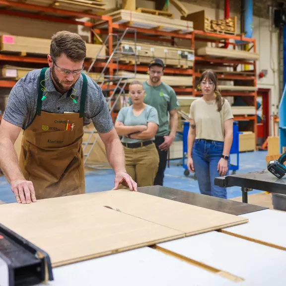 Carpenter instructor cutting wood