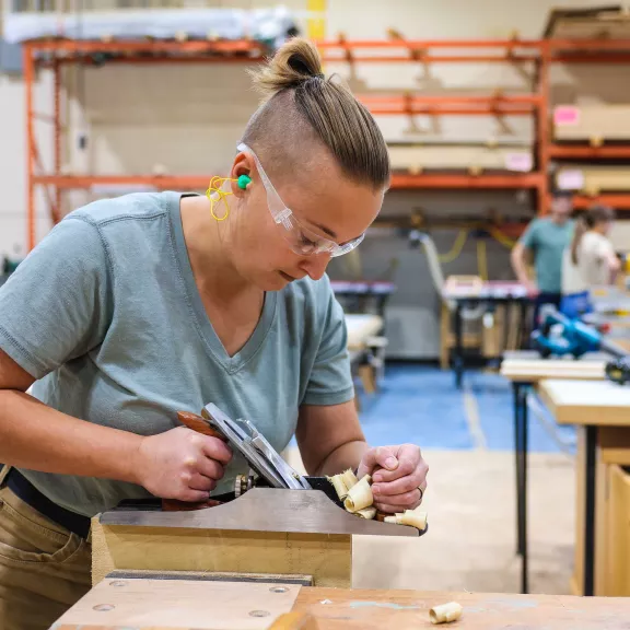 Carpenter student chipping wood