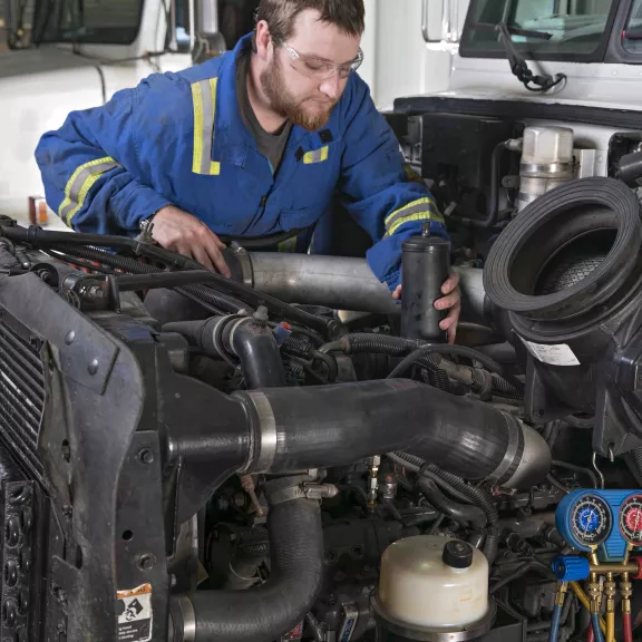 Student working on big truck engine