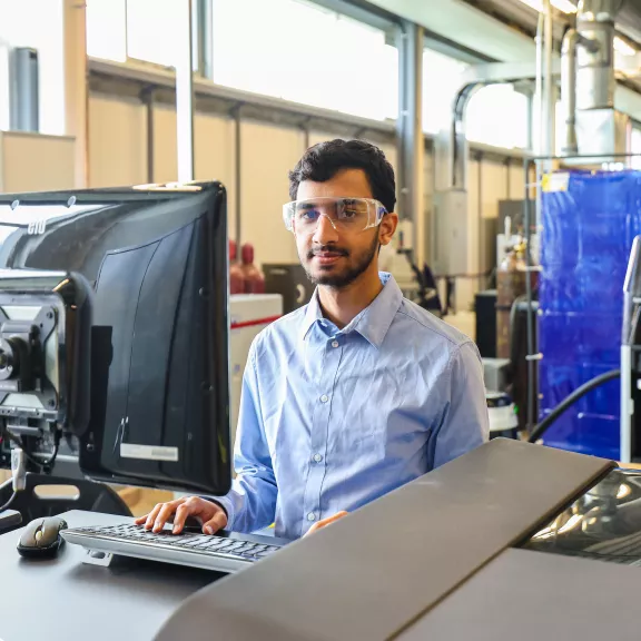 Student working in CIM-TAC using equipment