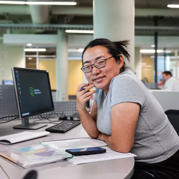 Student working on a desktop in the library.