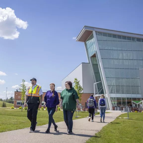 students walking with security