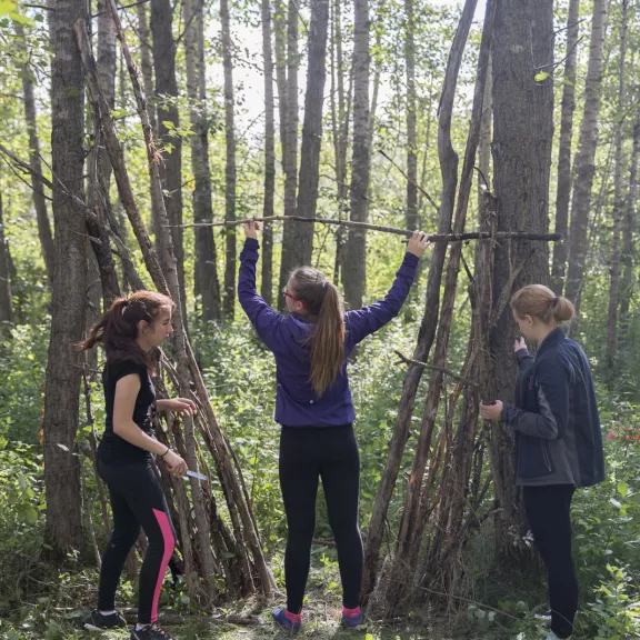 Three kids exploring in the forest