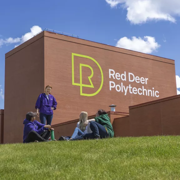 group of friends sitting in front of RDP logo